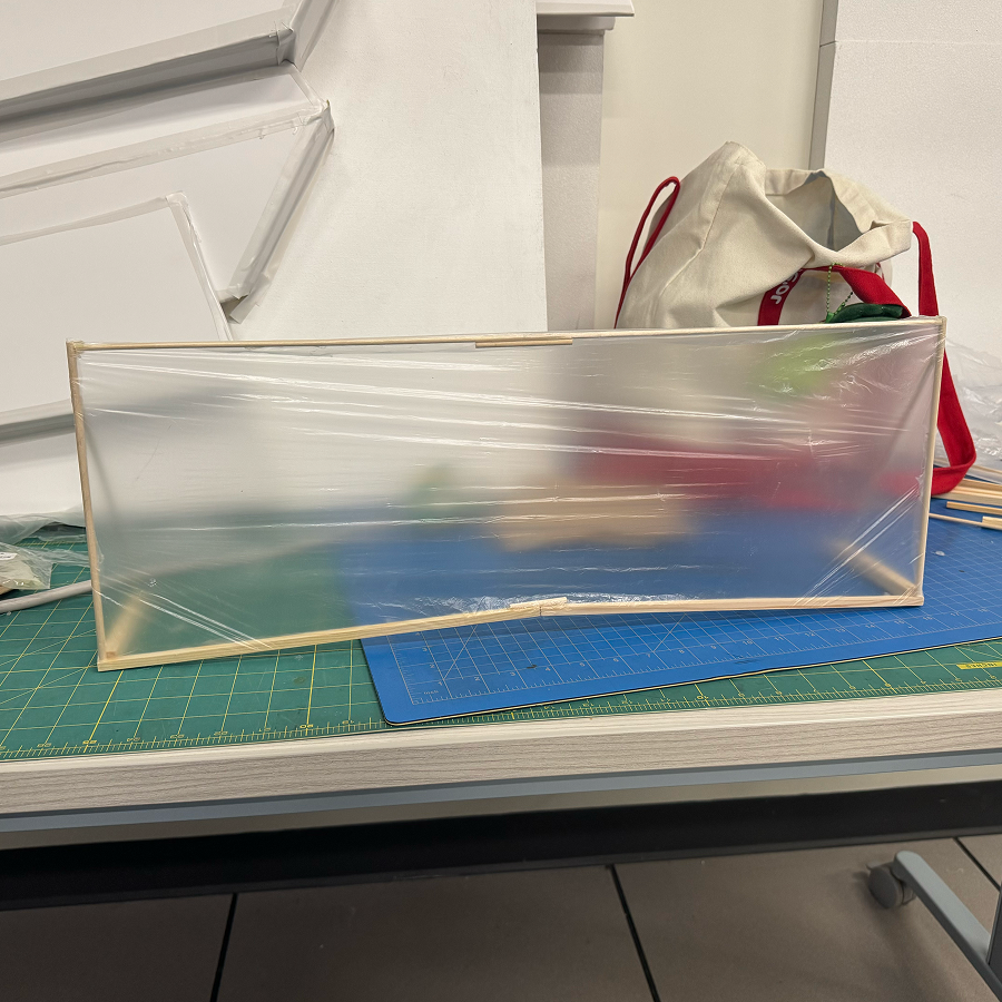 We created a larger windsheild prototype using a plastic bag and wooden sticks. This allowed us to have a bigger area to project our interface onto and was more close to the intended size of the projection (onto the driver's side of the windshield).